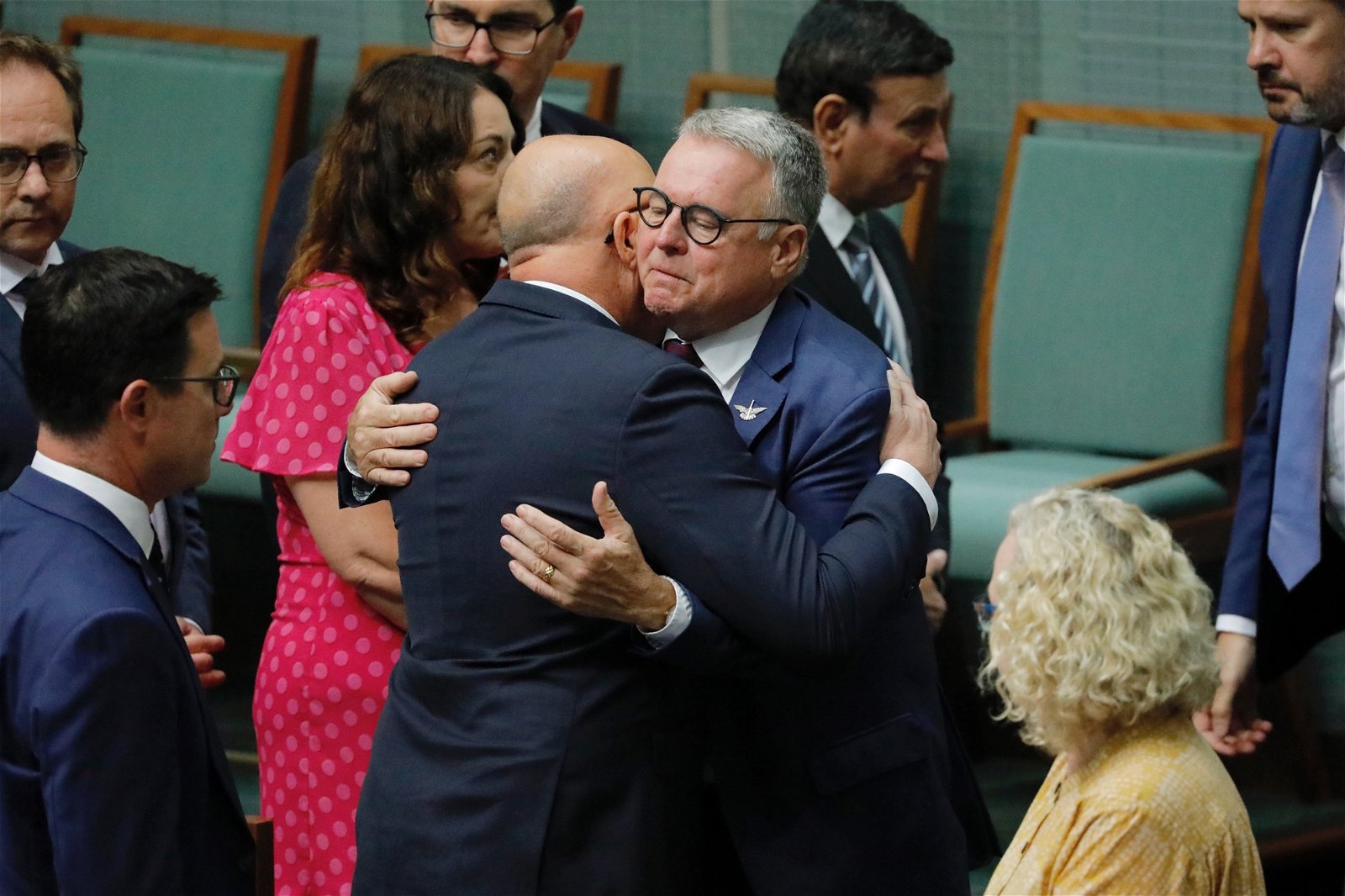Peter Dutton hugging a man in glasses. 
