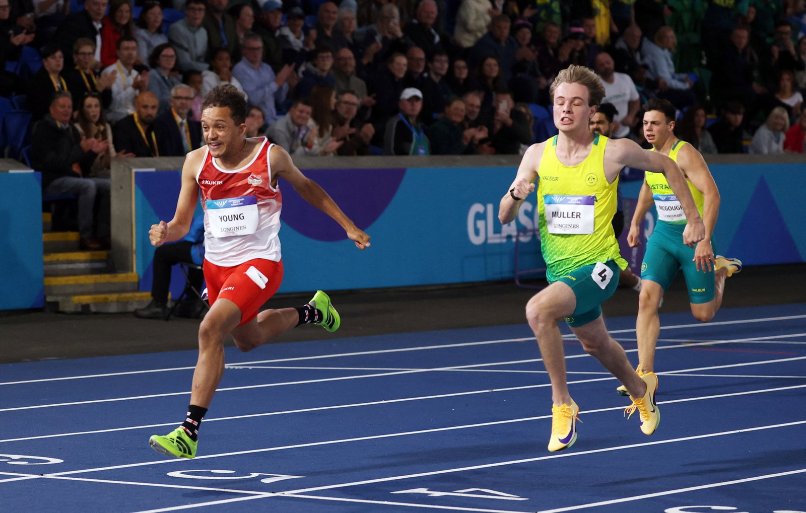 England's Thomas Young crosses the finish line to win the men's 100m t38 final ahead of second place Australia's Ullrich Mulle