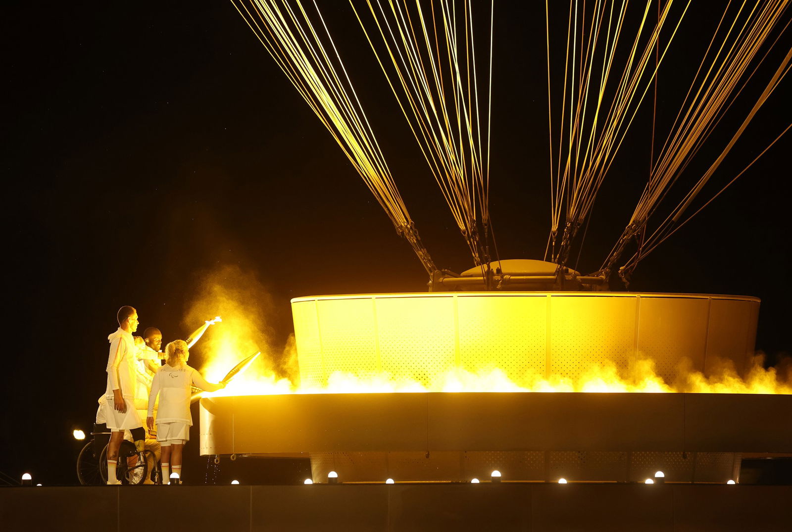 Charles Antoine Kouakou, Fabien Lamirault, Elodie Lorandi, Nantenin Keita and Alexis Hanquinquant light the cauldron at the Paris Opening Ceremony.