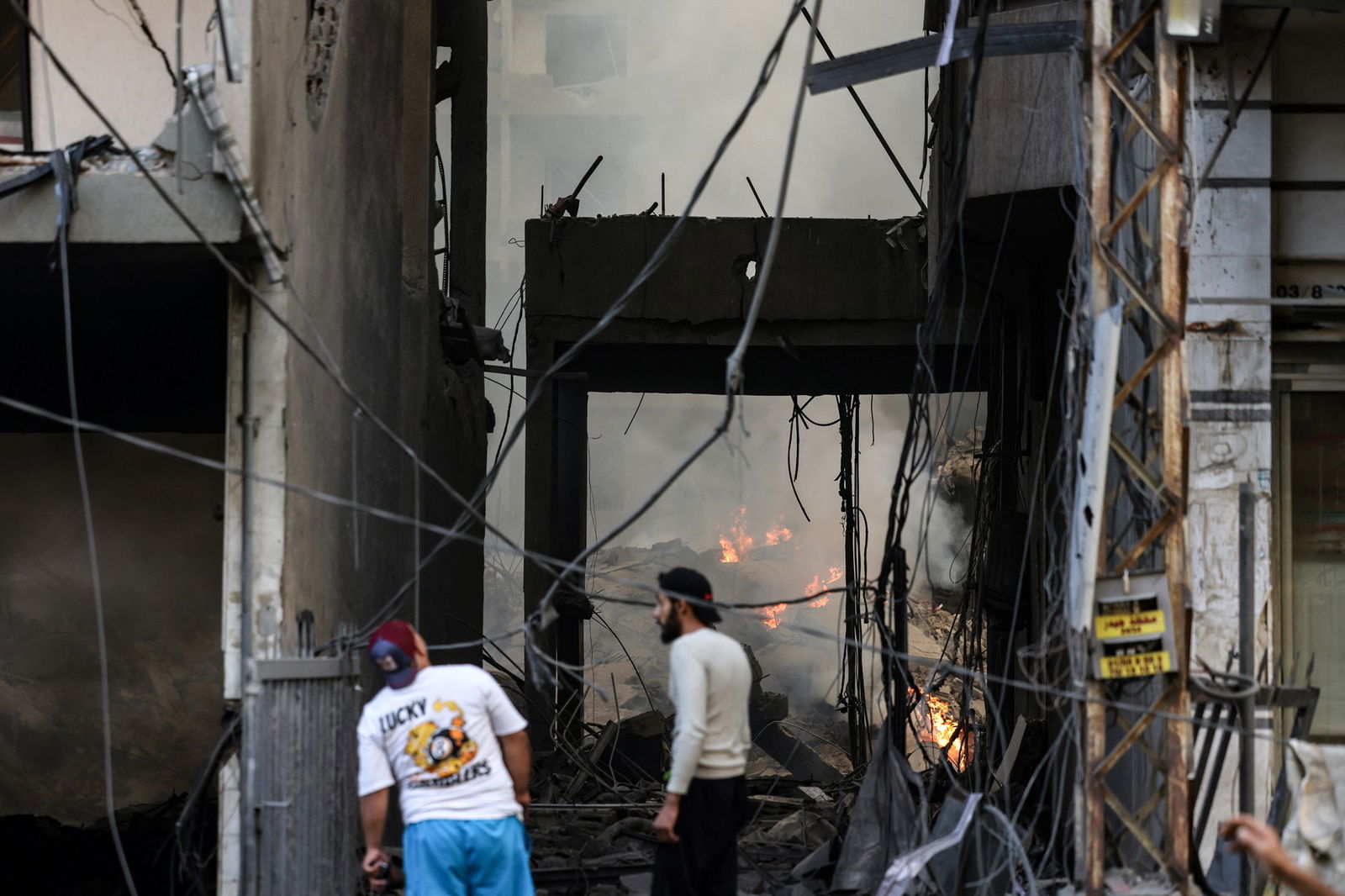 Residents check the damage after Israeli air strikes.