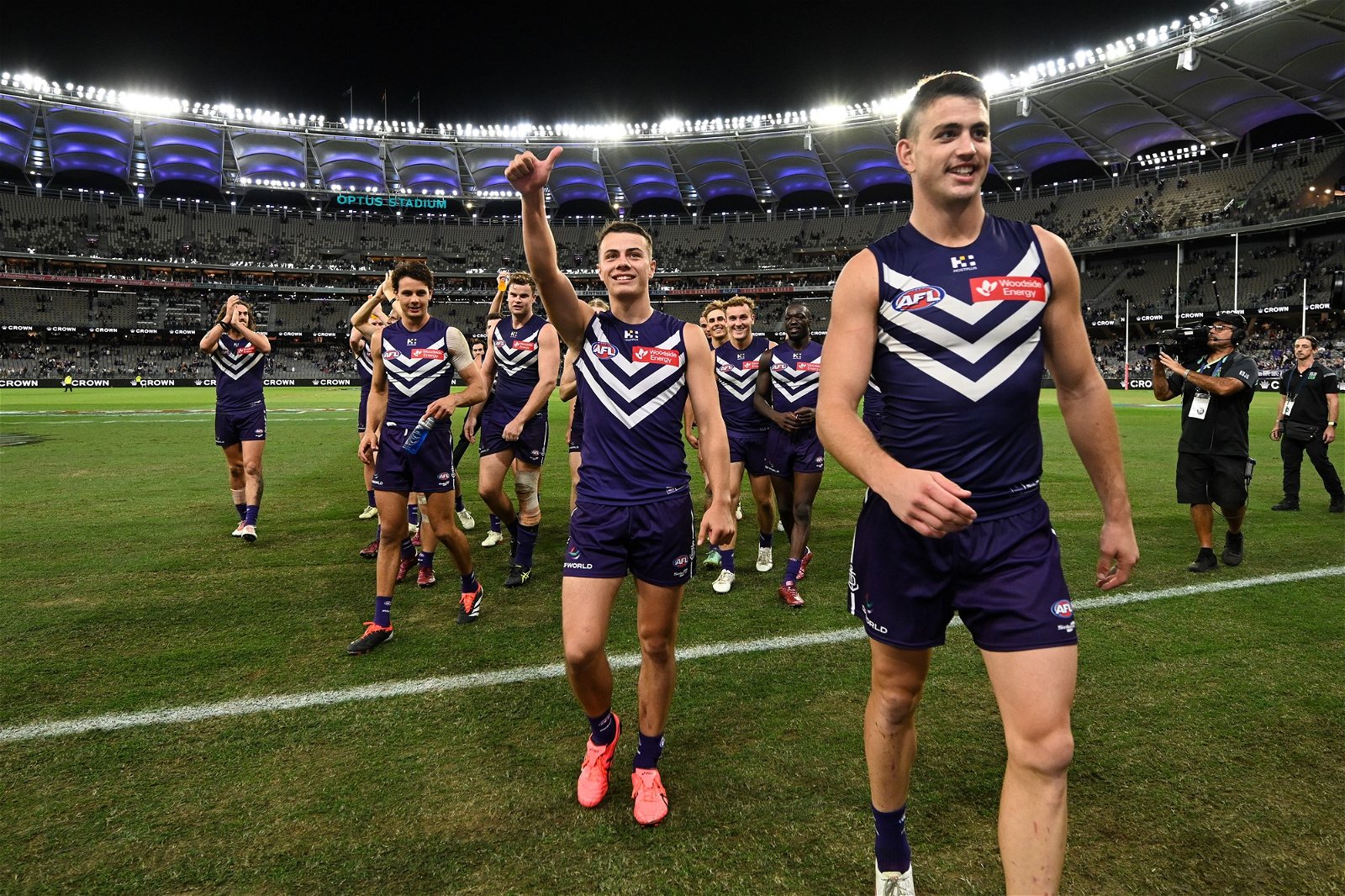 Cooper Simpson and Patrick Voss lead the Dockers off the ground after a win over the Bulldogs.