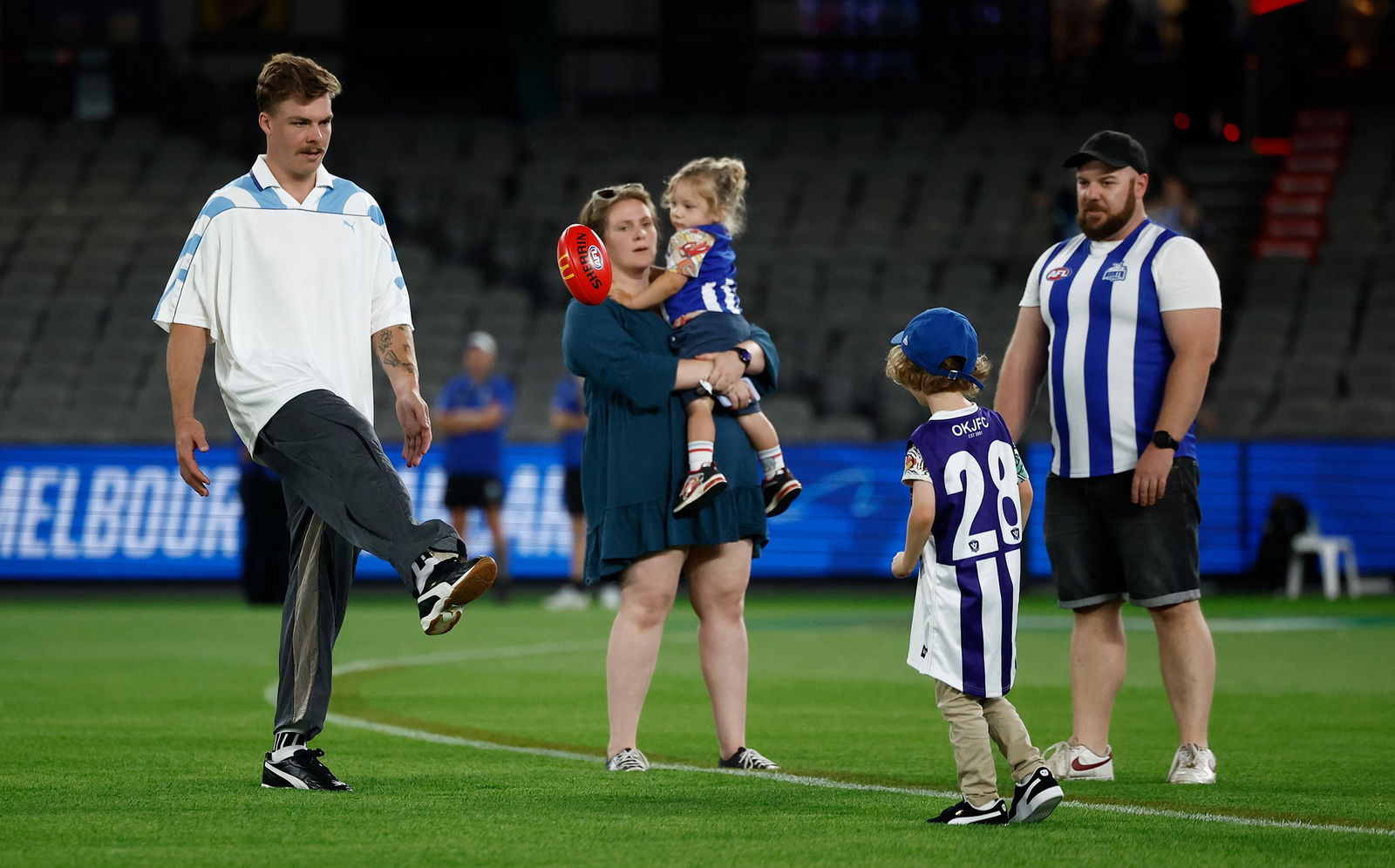 North Melbourne vs Carlton live: Good Friday Appeal footy pits Kangaroos and Blues and raises money for sick kids Rehmat Boutique Cam Zurhaar with Logan and his family