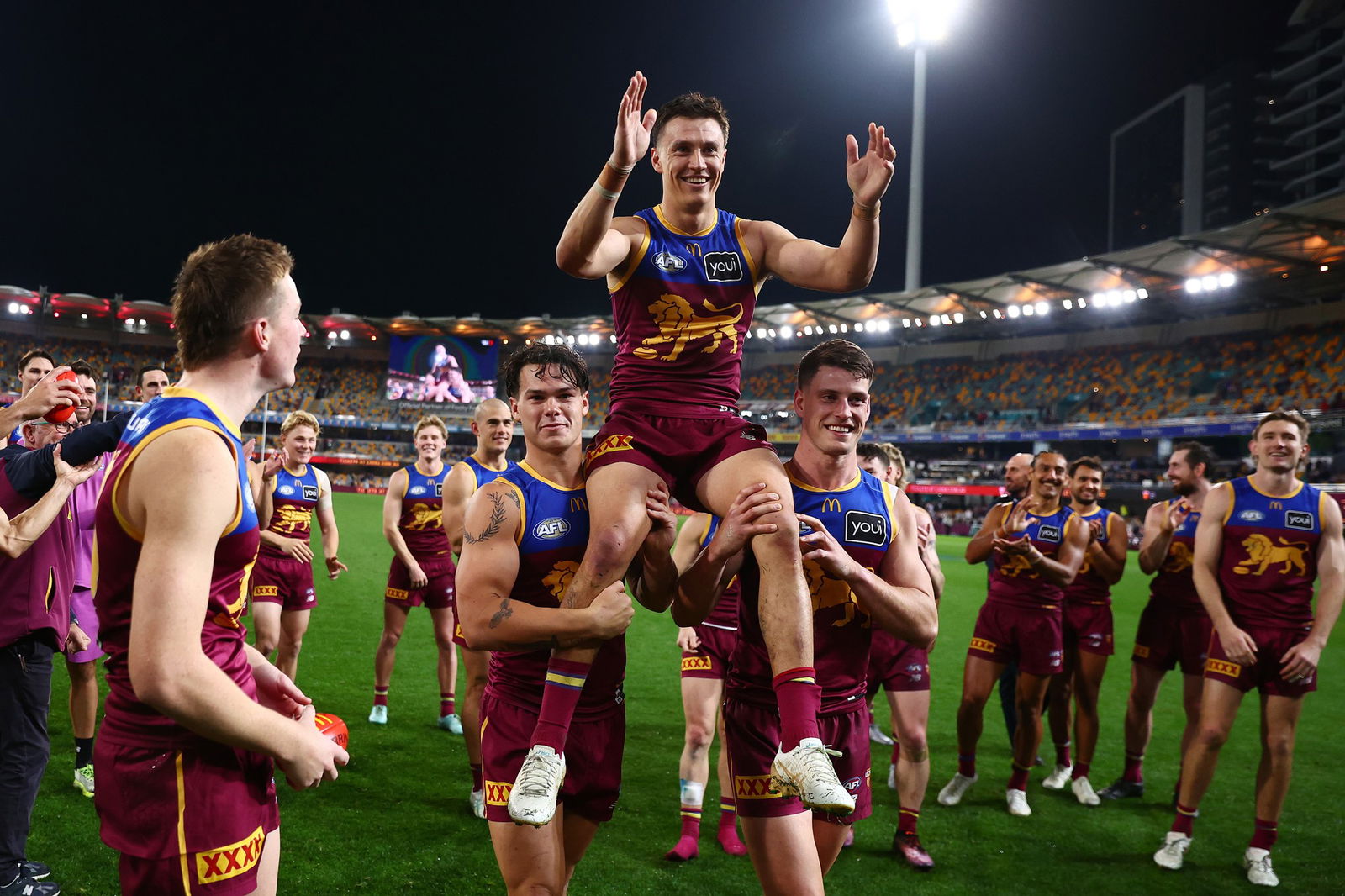 Hugh McCluggage of the Lions is chaired from the field after his 200th match after the round 19 AFL match between Brisbane Lions and Western Bulldogs at The Gabba on July 18, 2025 in Brisbane, Australia.