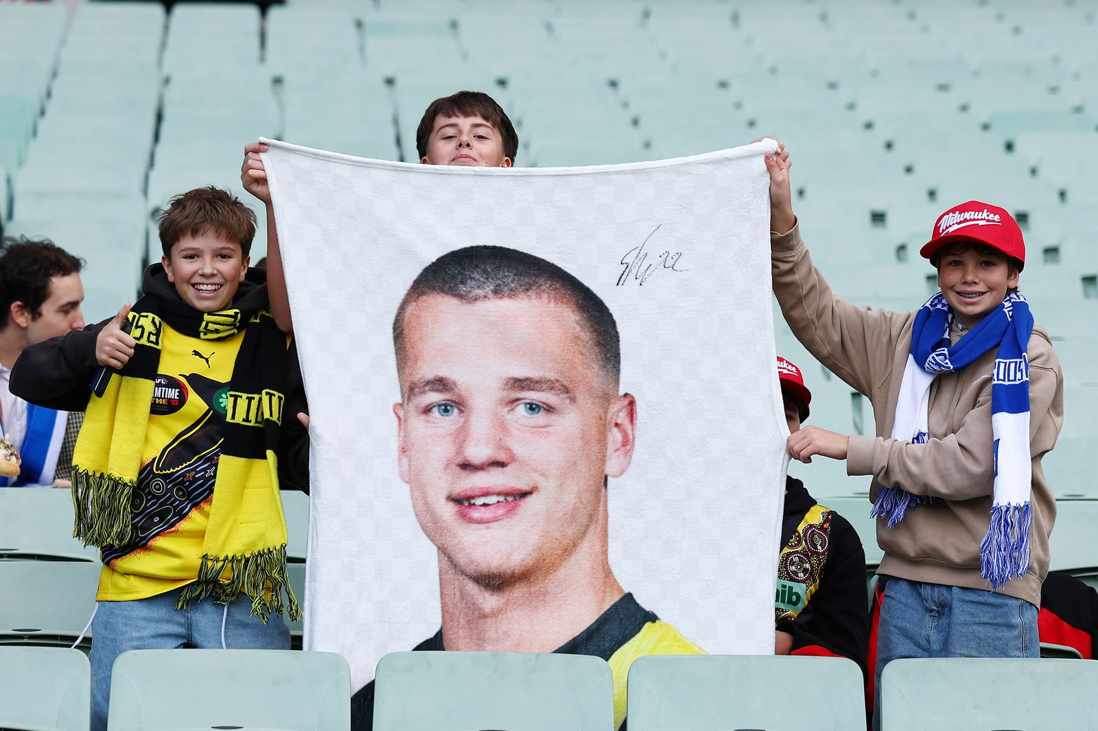 Fans hold up a Sam Lalor of the Tigers sign during the round ten AFL match between Richmond Tigers and North Melbourne Kangaroos at Melbourne Cricket Ground, on May 18, 2025, in Melbourne, Australia.