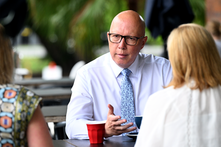 Peter Dutton sits down with a coffee.