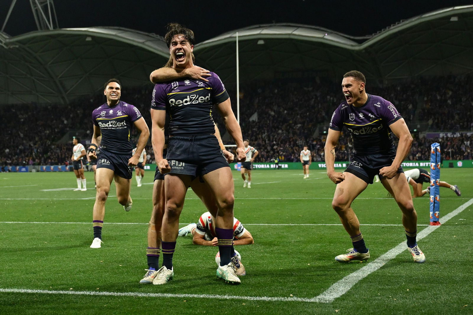 Jack Howarth shouts to celebrate a try in an NRL game for the Melbourne Storm.