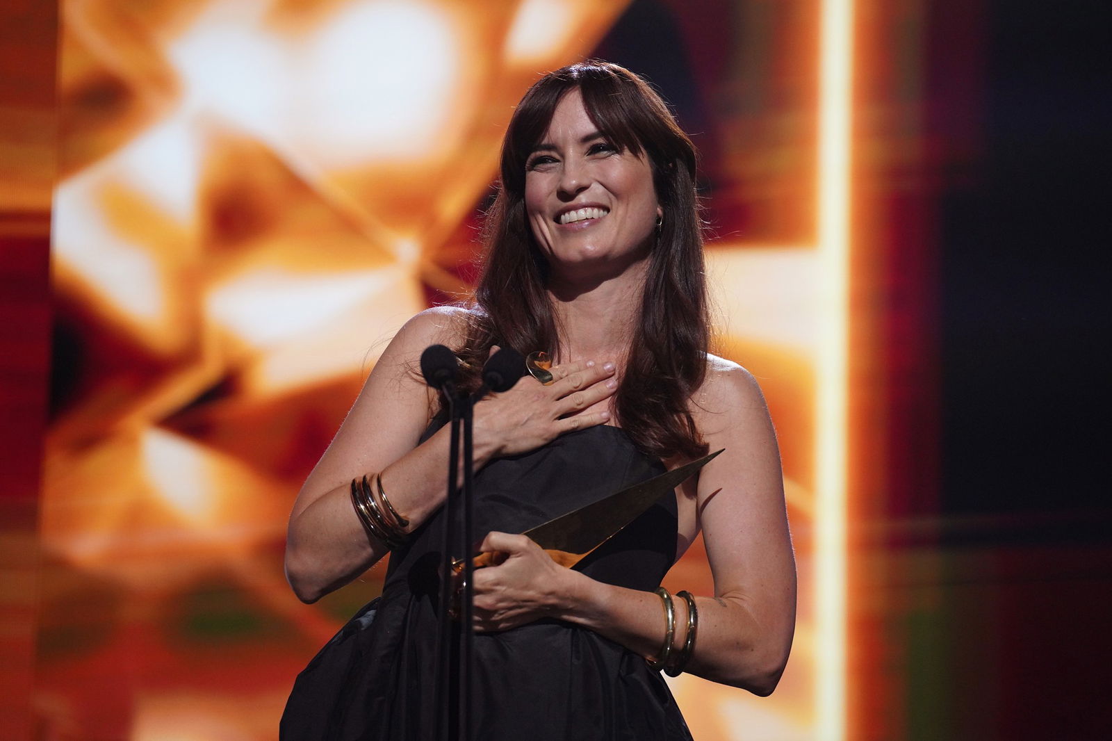 Missy Higgins smiling holding an award. 