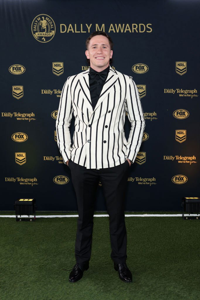 Cooper Johns on the red carpet at the Dally M Awards wearing a black and white striped jacket.