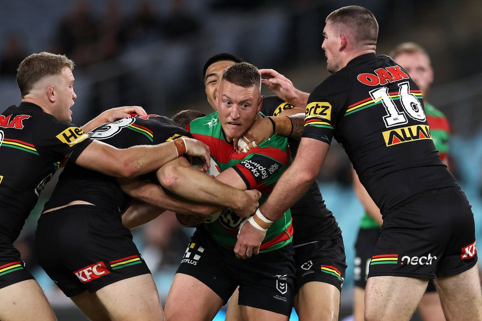 South Sydney Rabbitohs' Sean Keppie is tackled by a number of Penrith Panthers during an NRL game.