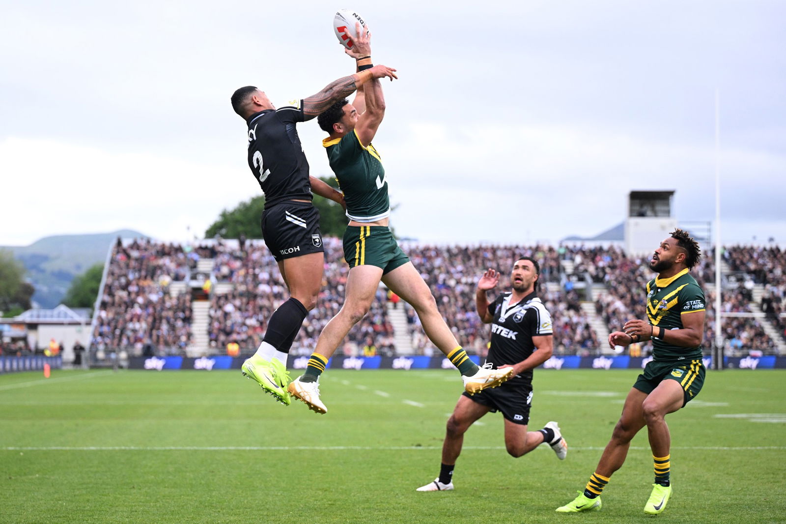 Xavier Coates catches the ball in front of Jamayne Isaako in a rugby league Test.