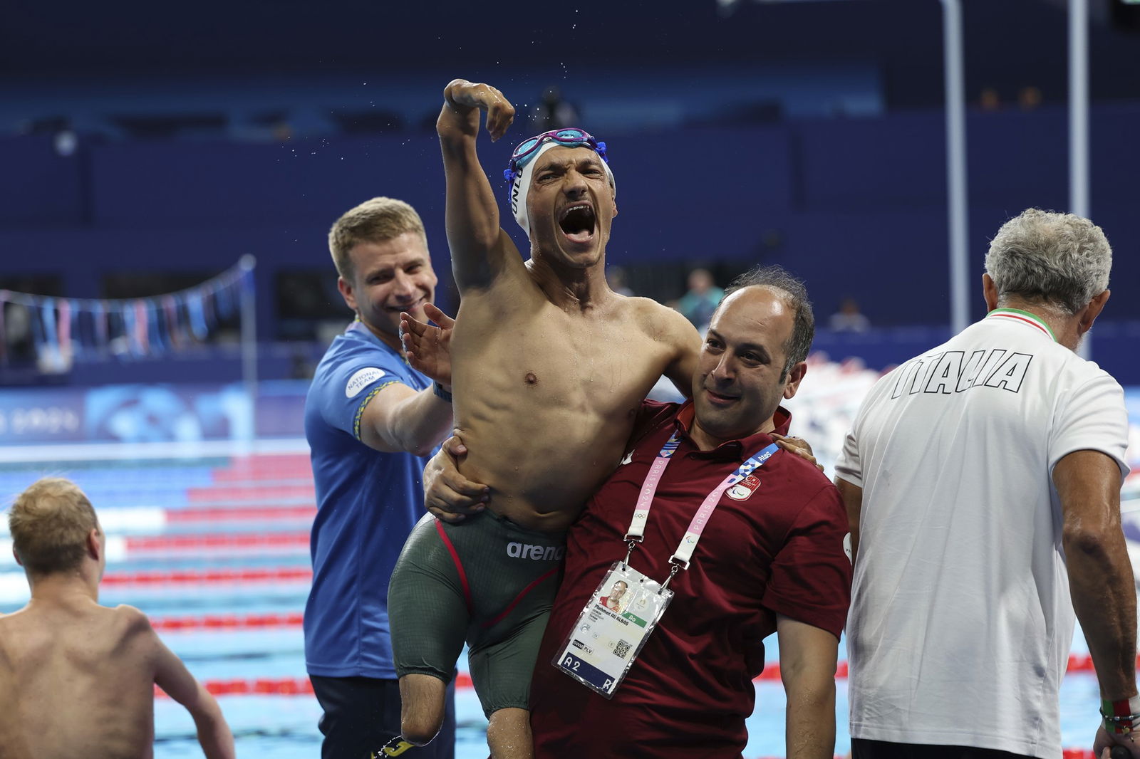 Turkey's Umut Unlu, carried by Mehmet Ali Albas, celebrates winning the men's 50 freestyle S3 final in Paris.