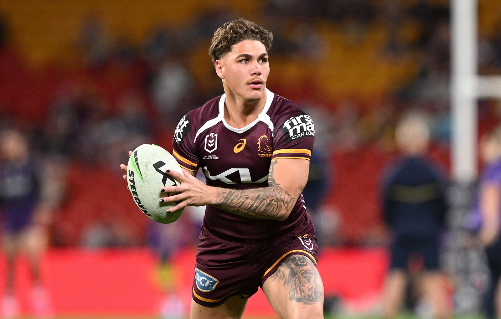 A man looks to pass the ball during a rugby league match