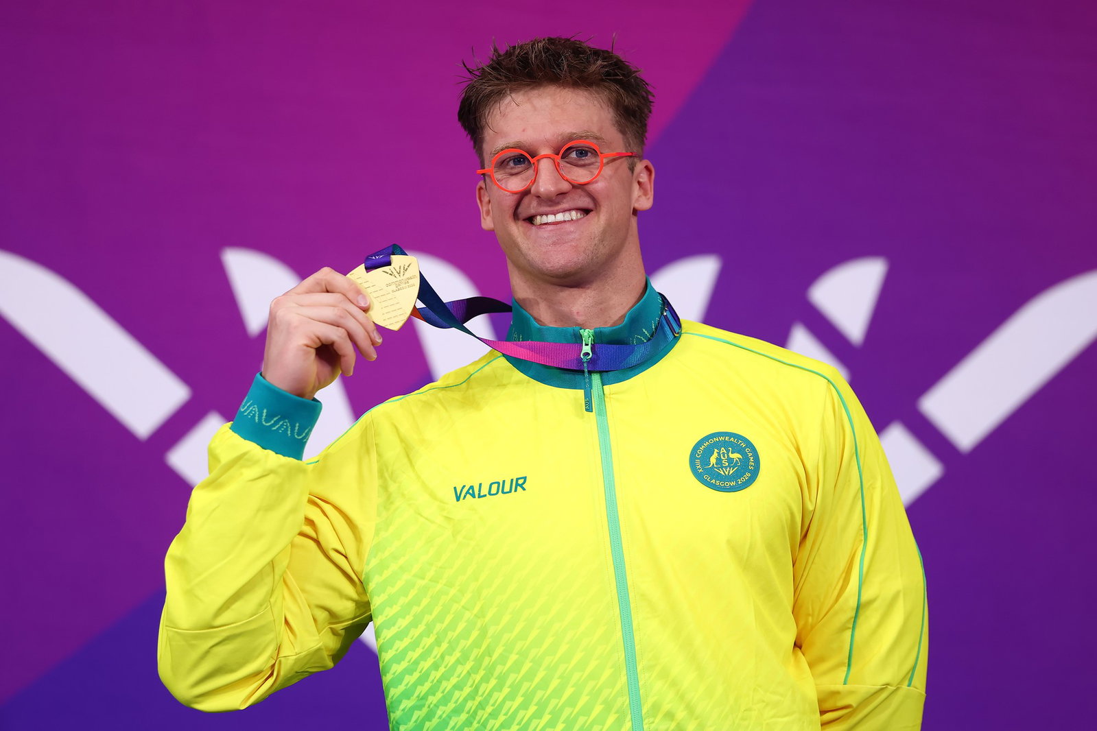 Sam Williamson smiling with his medal
