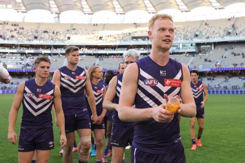 Hugh Davies and the Fremantle Dockers leave the field after a win over Gold Coast.