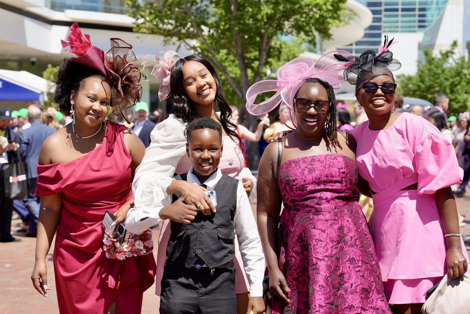 A group of women and a young boy smile at the camera.