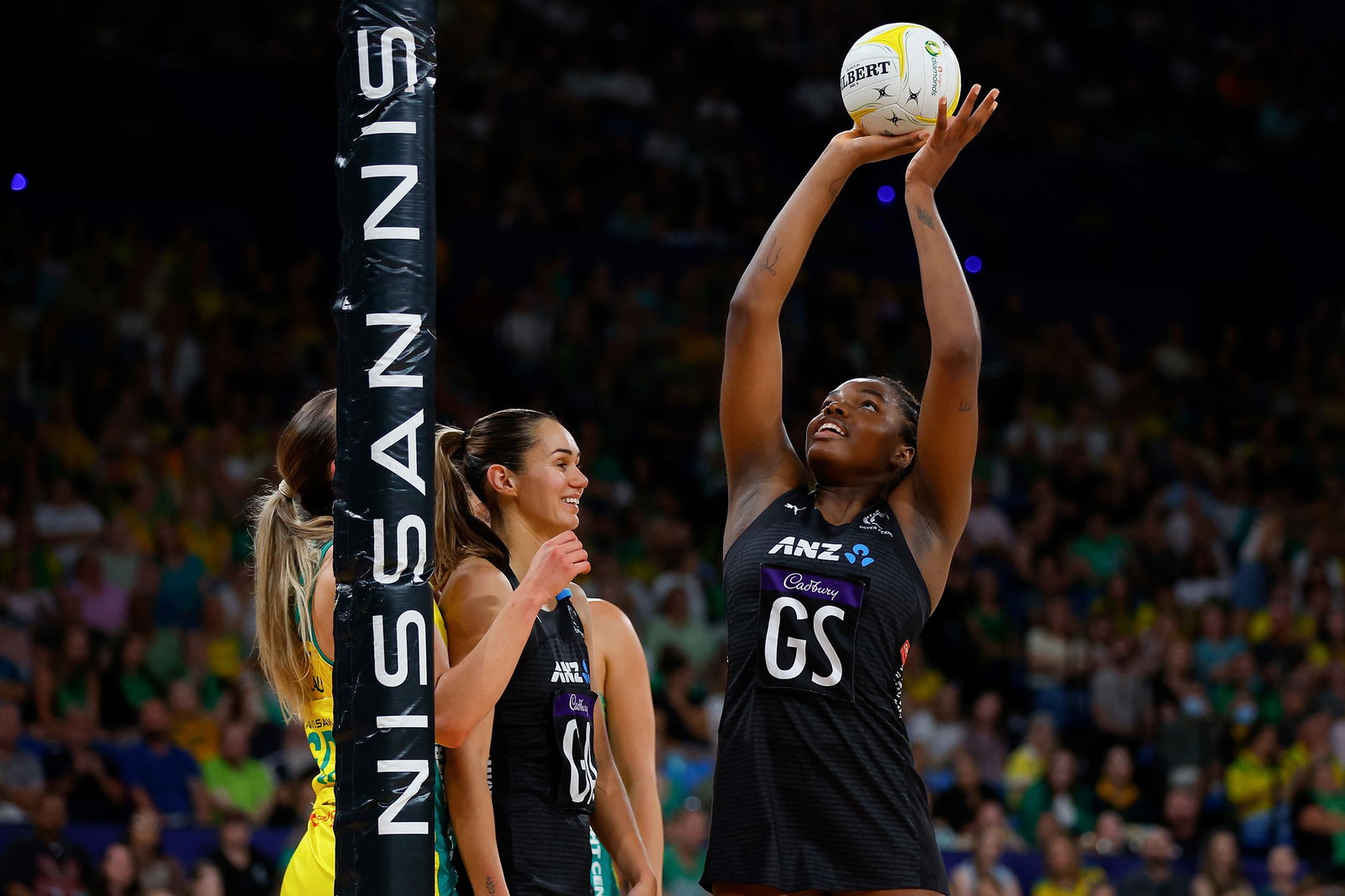 A player holds the ball above their head as they aim for goal