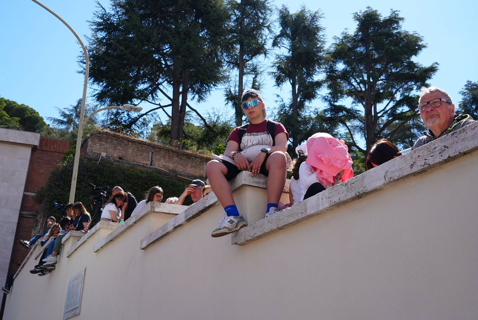 A boy sits on a wall
