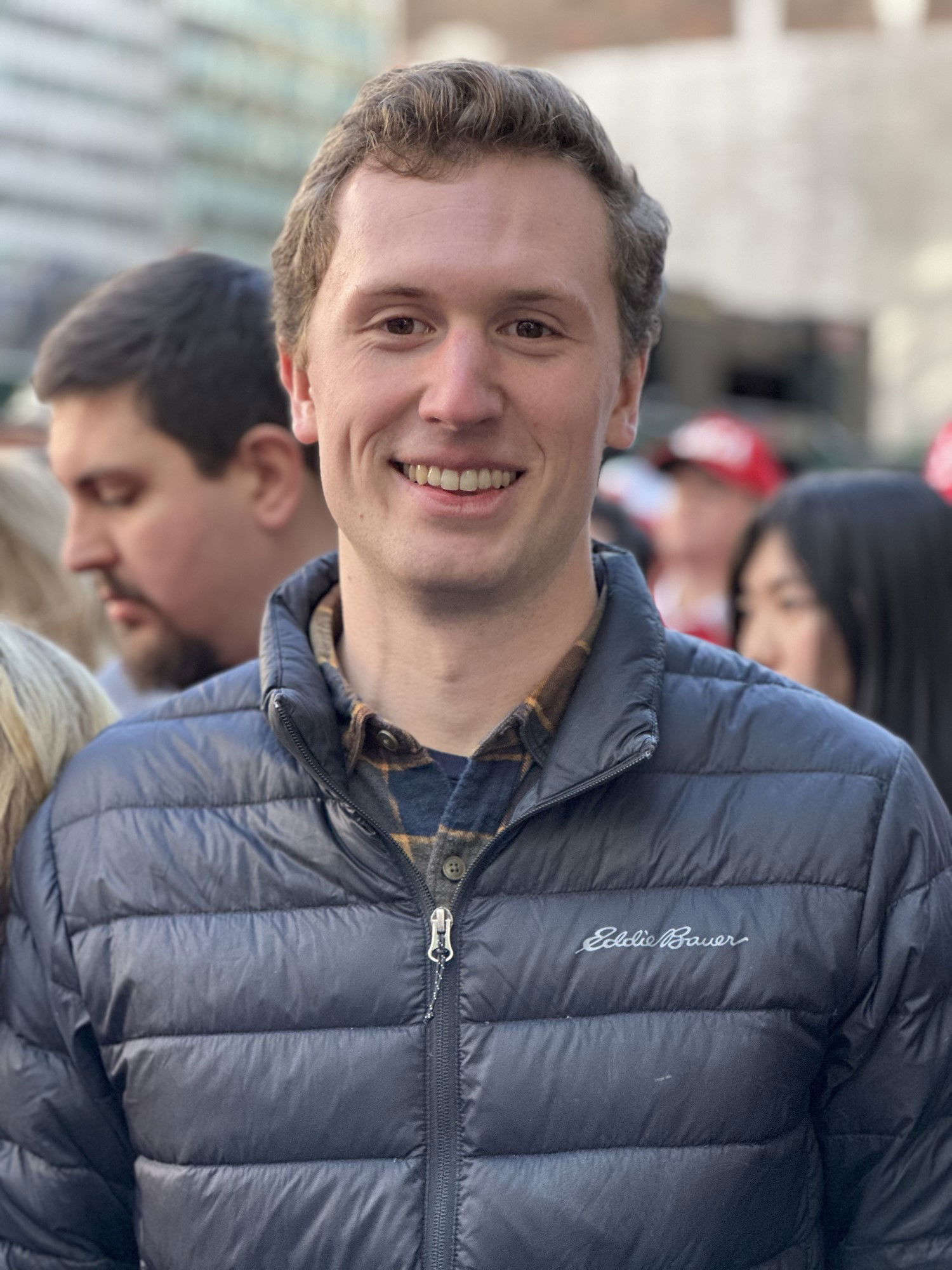 Alex Kiel smiles while waiting in line for a Trump rally