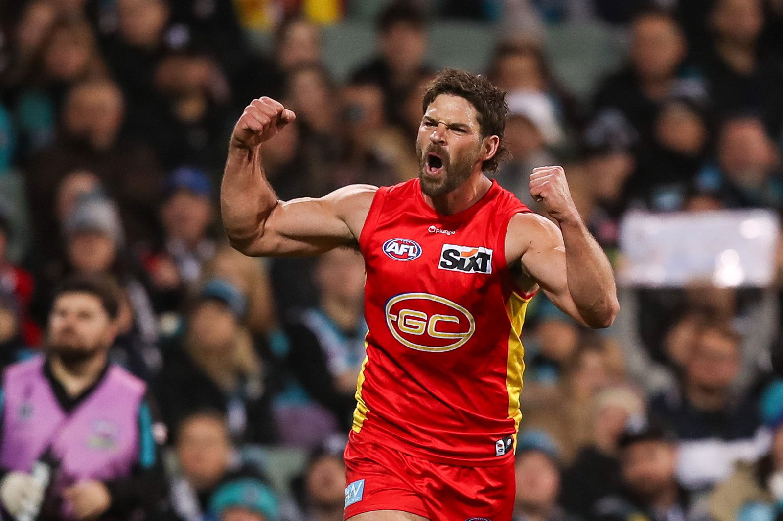 Levi Casboult of the Suns celebrates a goal, punching both fists in the air