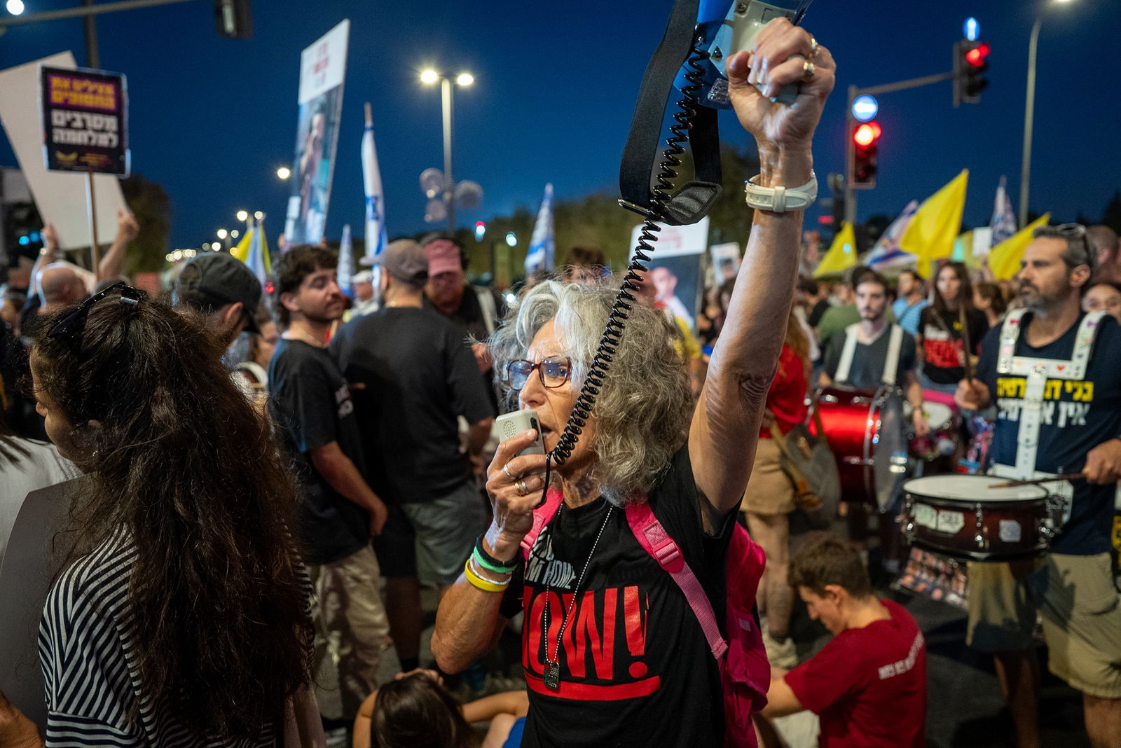 A woman holds a loudspeaker.