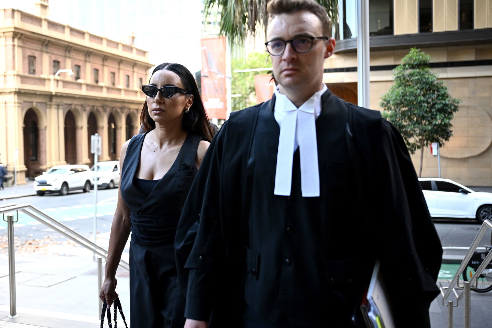 Two people walk into court.
