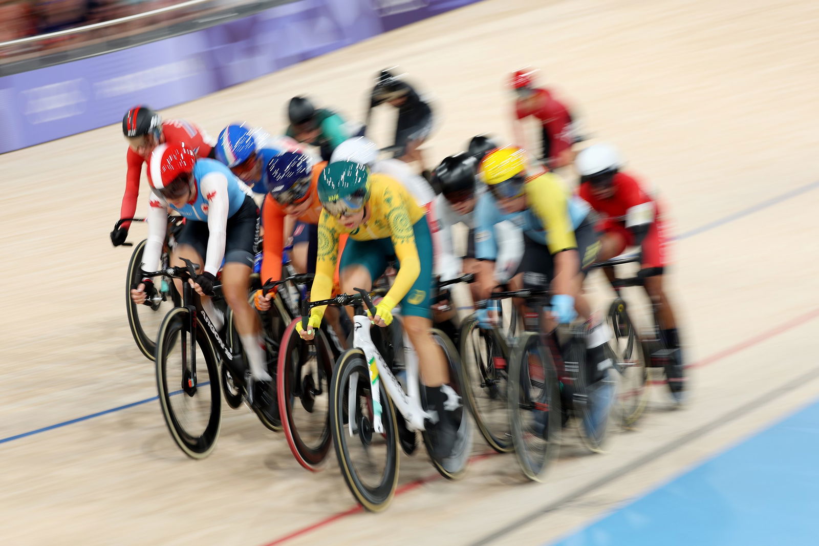 Maggie Coles-Lyster of Team Canada, Maike van der Duin of Team Netherlands, Georgia Baker of Team Australia and a general view of the peloton competing during the Women's Omnium, Elimination Race 3/4 on day sixteen of the Olympic Games Paris 2024 at Saint-Quentin-en-Yvelines Velodrome on August 11