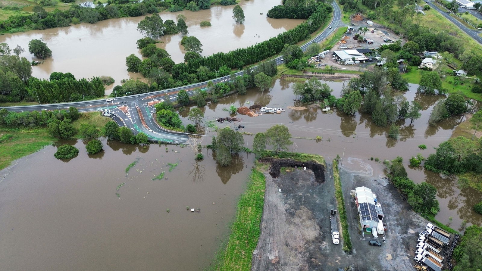 An aerial shot of a highway with flooding on either side