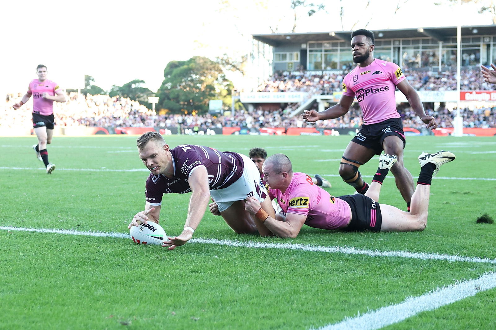 Tom Trbojevic grounds the ball as he is tackled by Dylan Edwards.