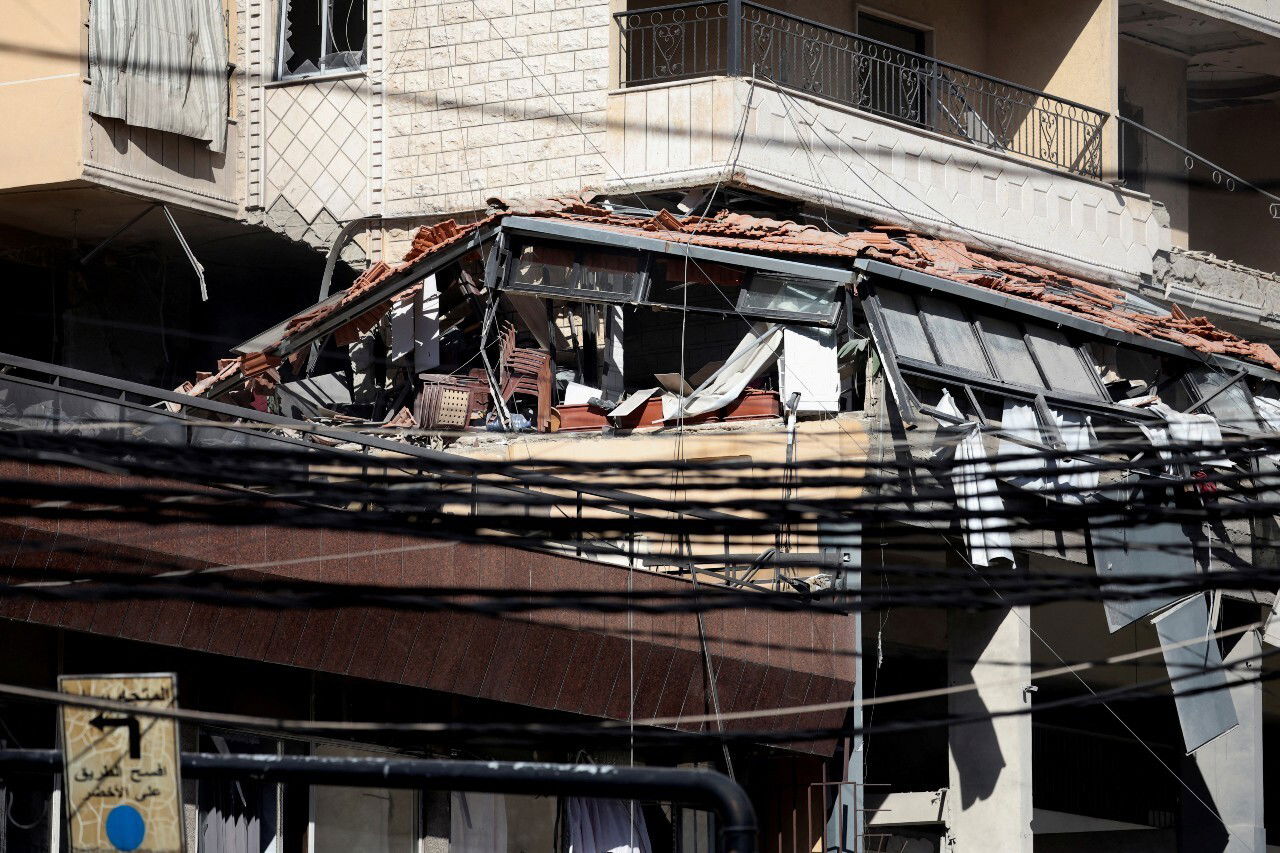 A building with significant damage visible.