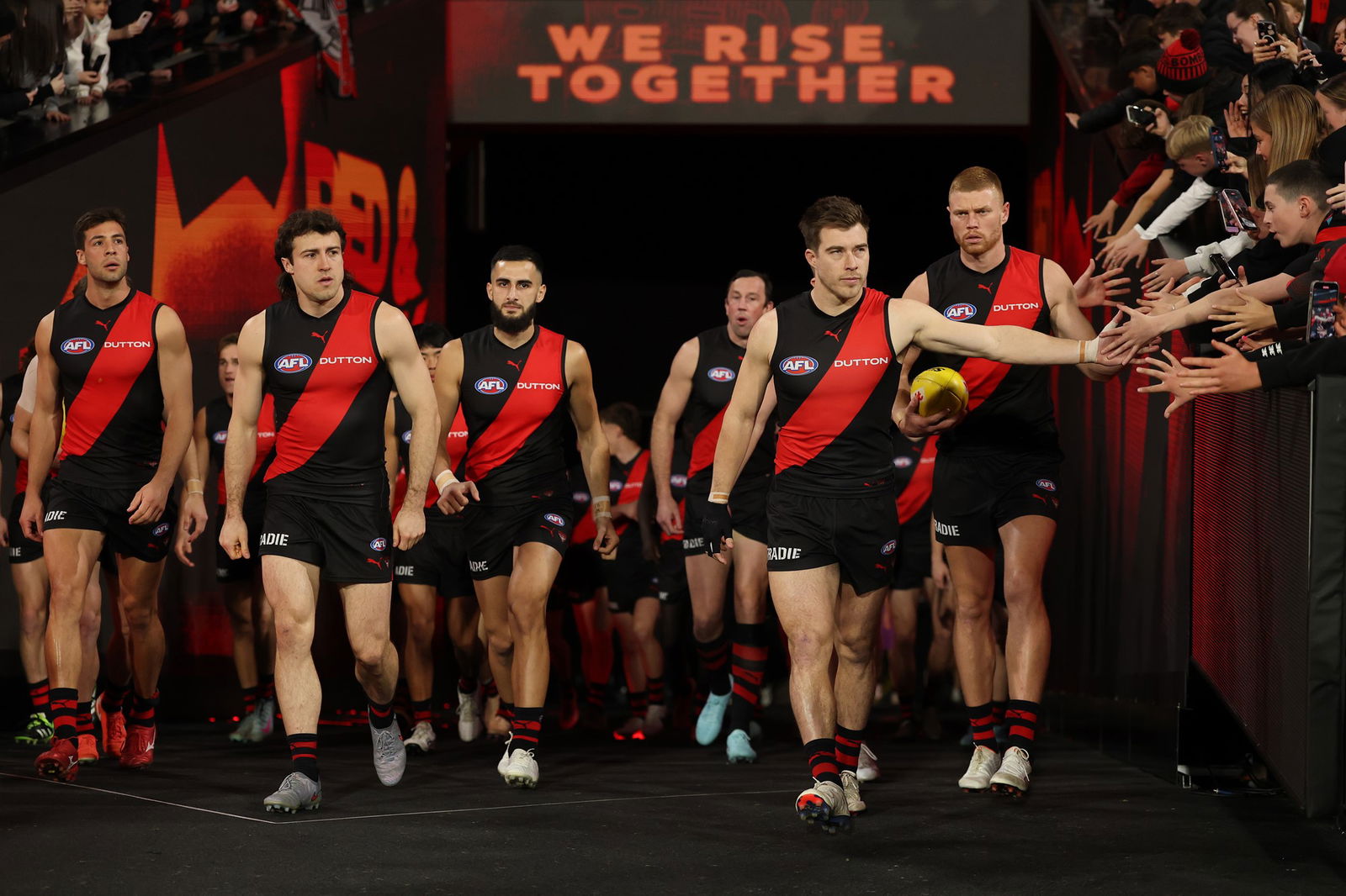 Zach Merrett leads out the Bombers