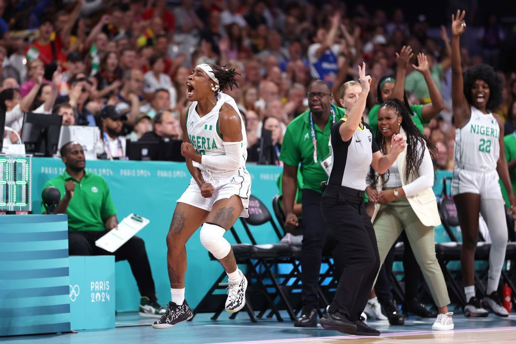 A woman screams with joy during a basketball game.