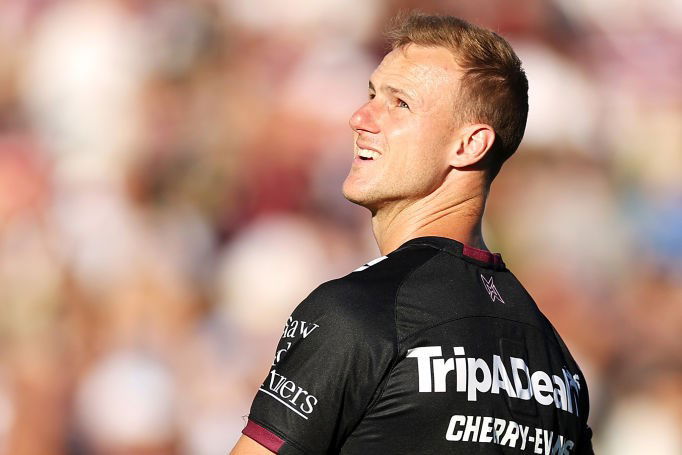 Daly Cherry-Evans looks up into the sun in warm-up gear.