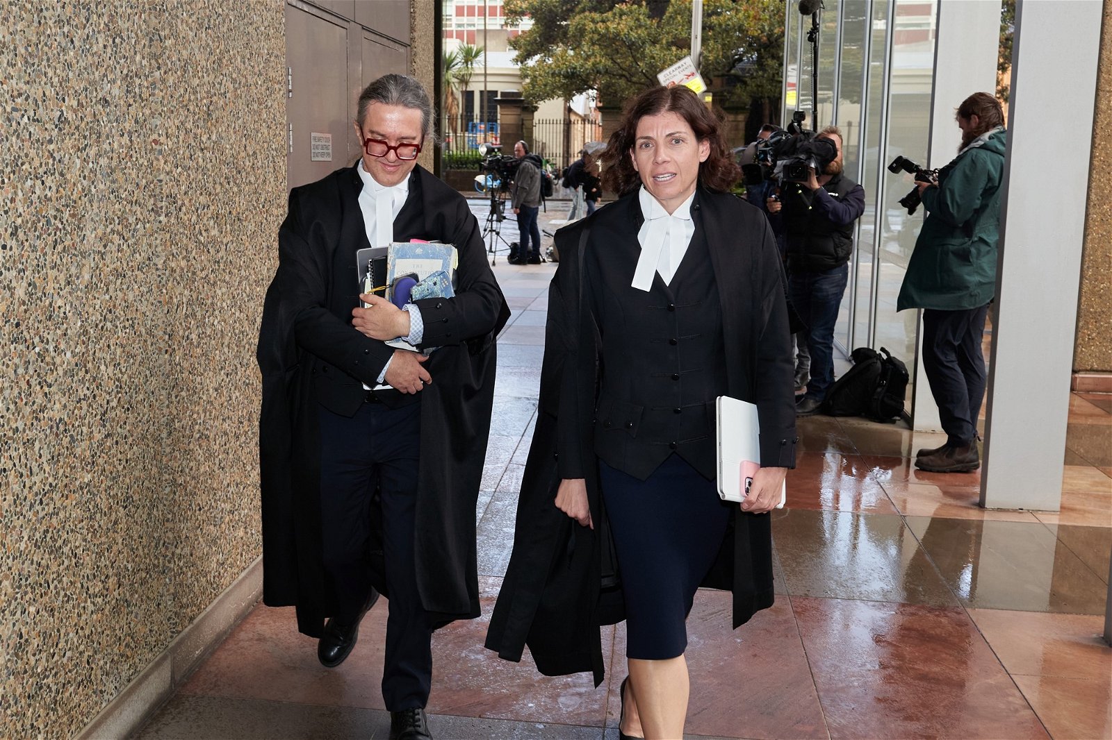 Barristers in robes leave court