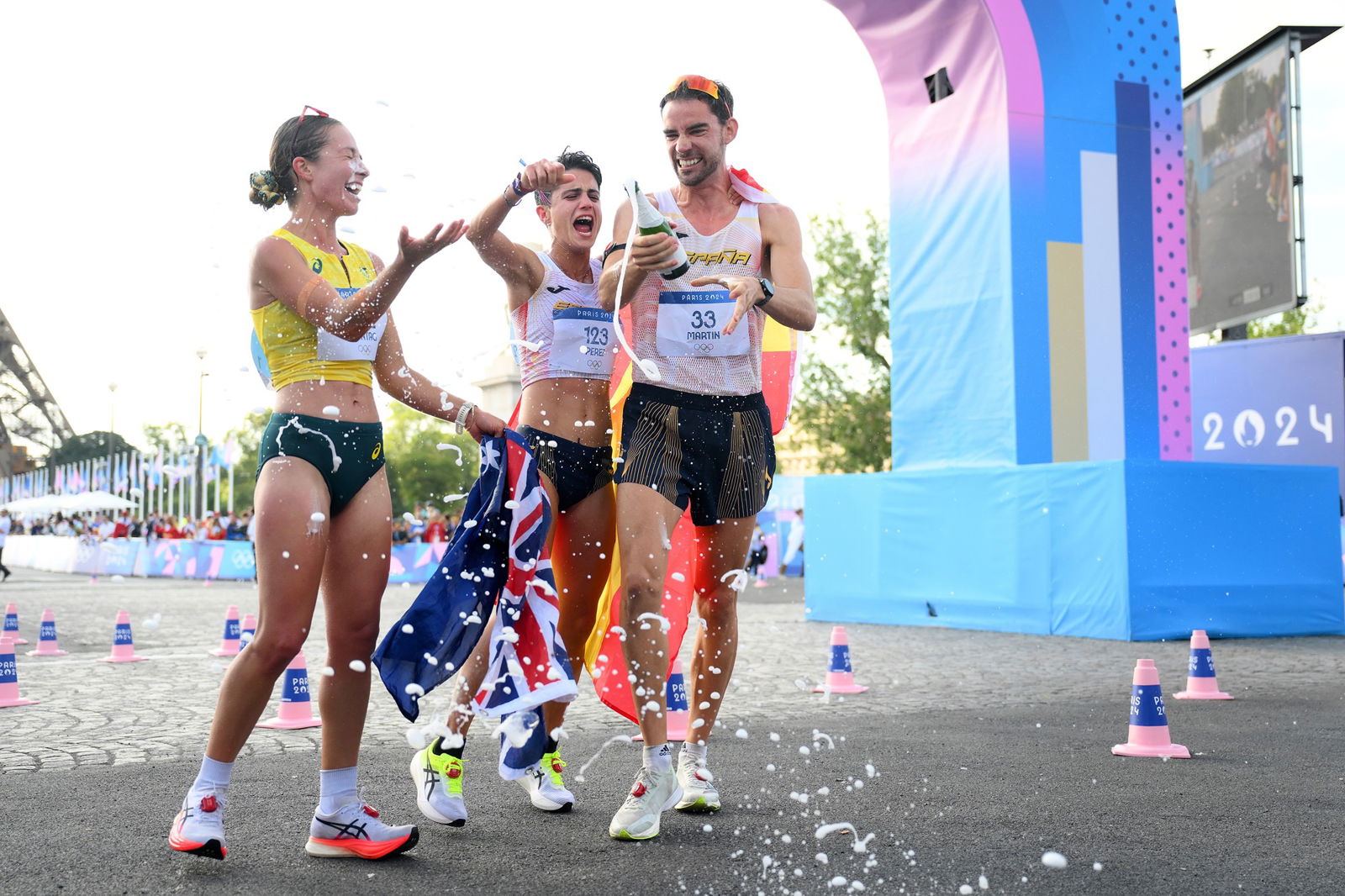 Jemima Montag of Team Australia, Maria Perez and Alvaro Martin of Team Spain celebrate after crossing the finish line during the Mixed Marathon Race Walk Relay on day twelve of the Olympic Games Paris 2024 at Stade de France on August 07, 2024 in Paris, France. (Photo by David Ramos/Getty Images)