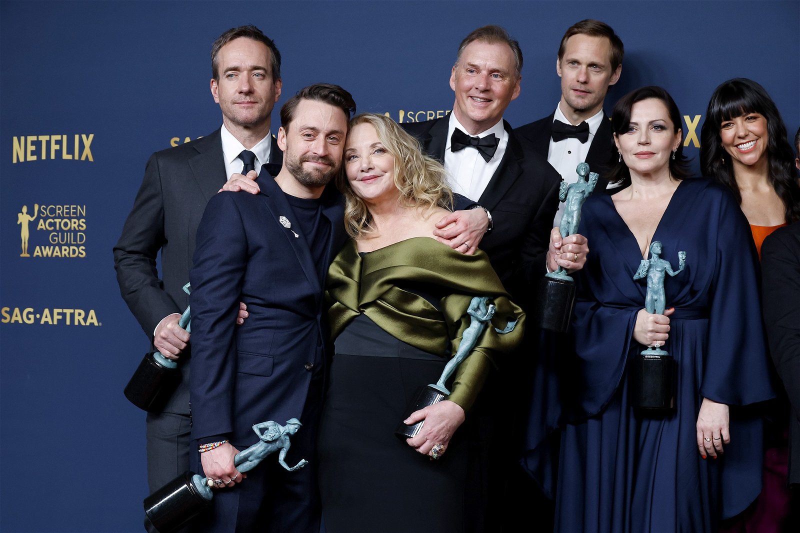 the Succession cast posing with their awards