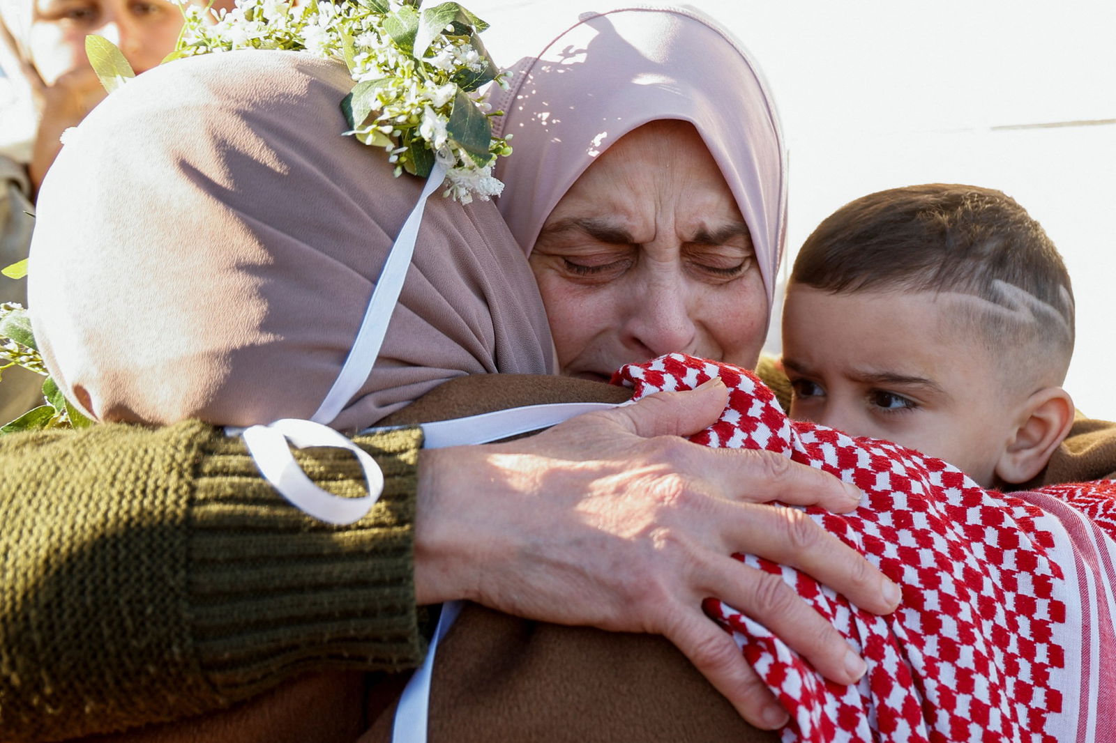 Nidaa Zaghebi embraces her mother-in-law and son