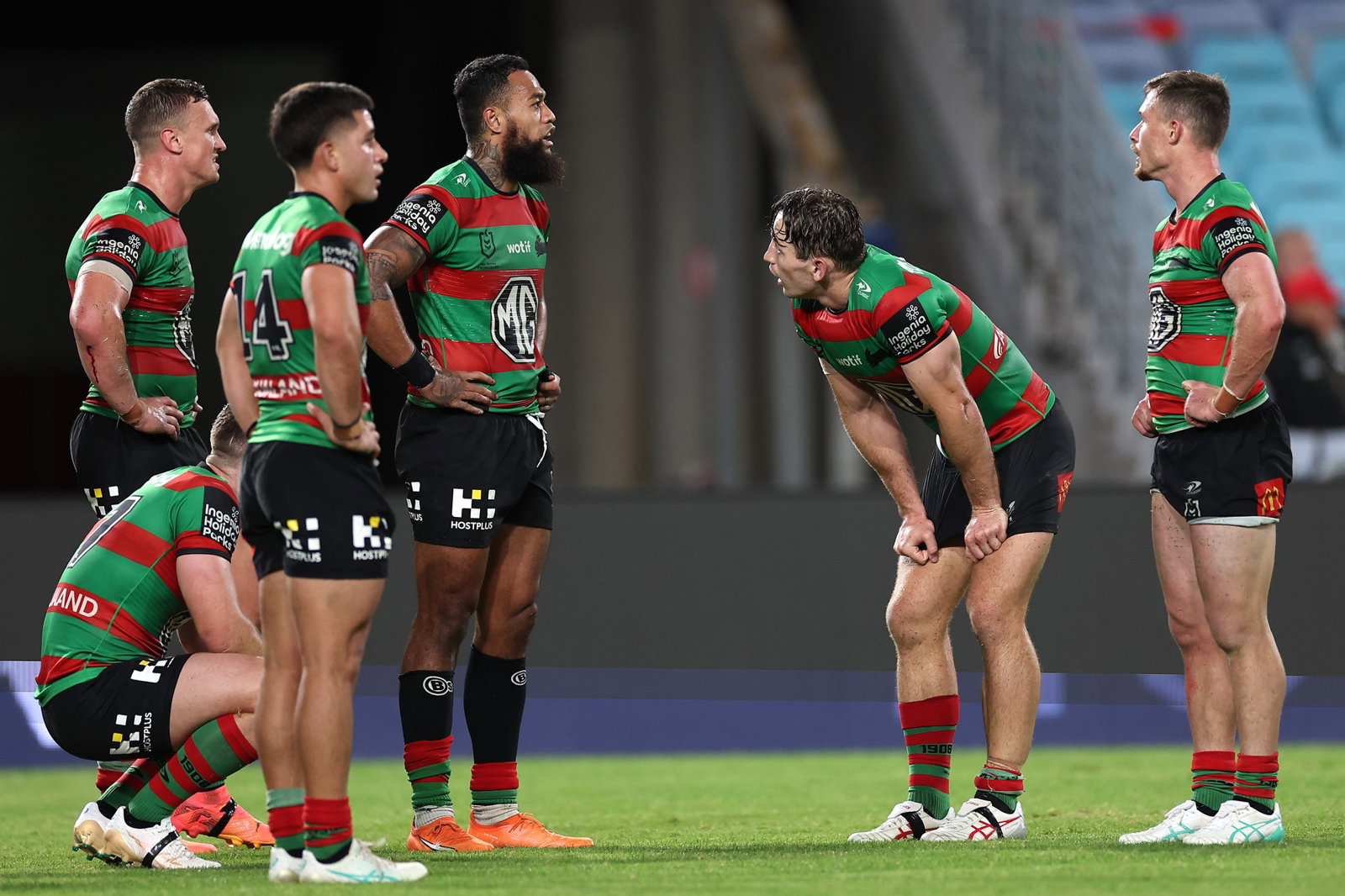 South Sydney Rabbitohs stand on the field during an NRL game.