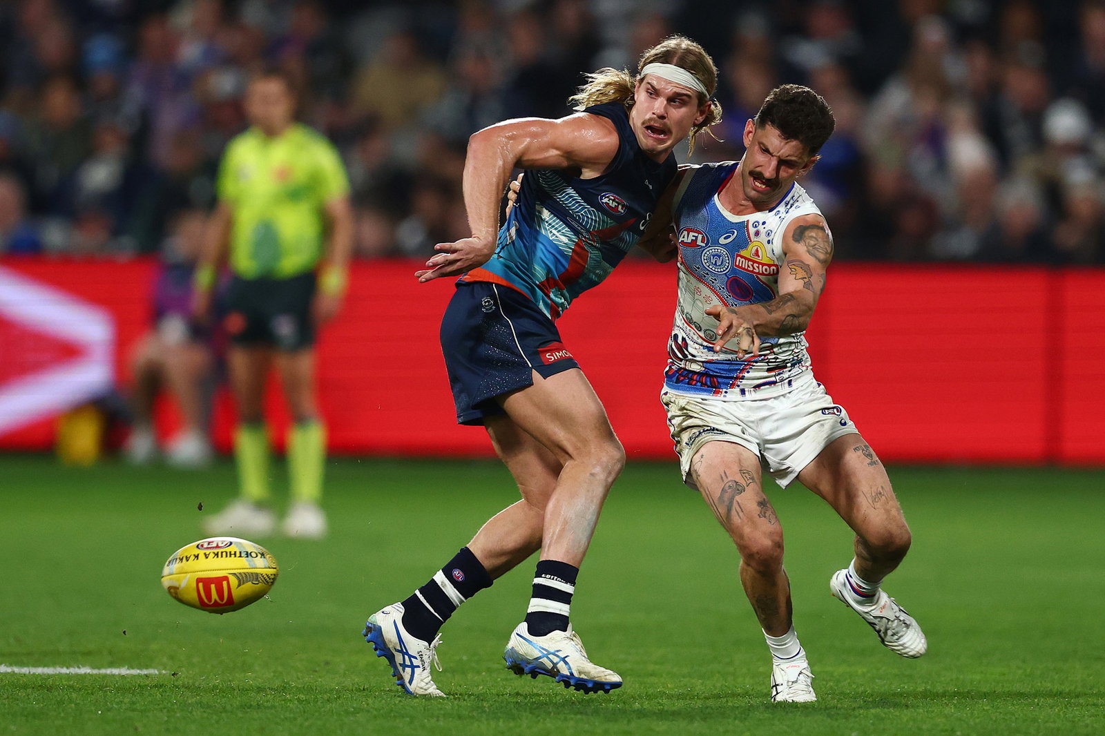 Geelong star Bailey Smith and Bulldogs veteran Tom Liberatore in action during last year's  clash between the two sides.