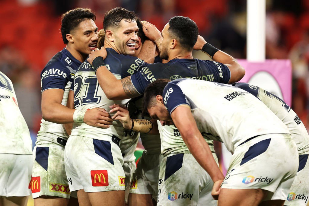 North Queensland Cowboys players celebrate a try against the South Sydney Rabbitohs.