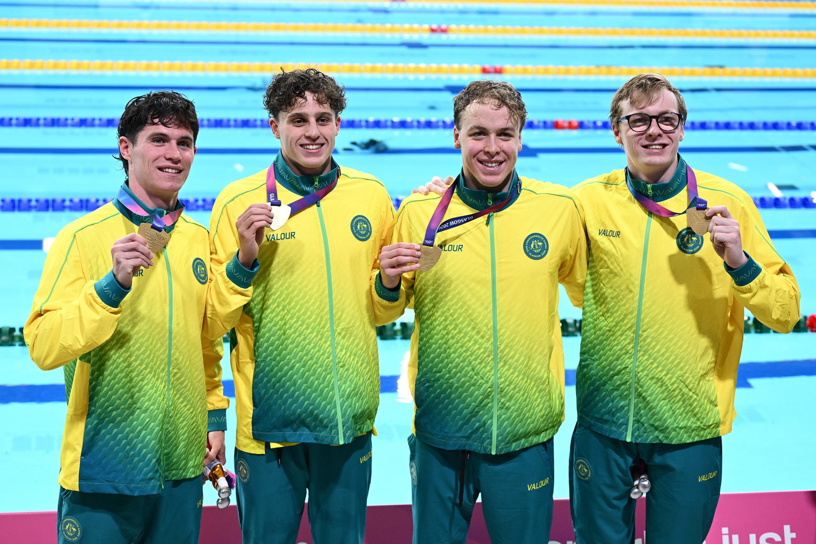 The men's 4x200m Aussie team posing for photos with the gold medals