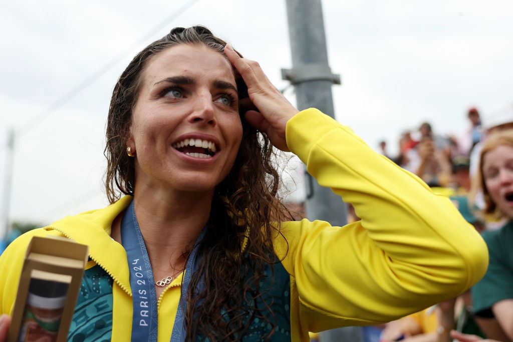 Jess Fox looks emotional as she touches her hair after winning the gold medal in the canoe slalom C1 at the Paris Olympics.