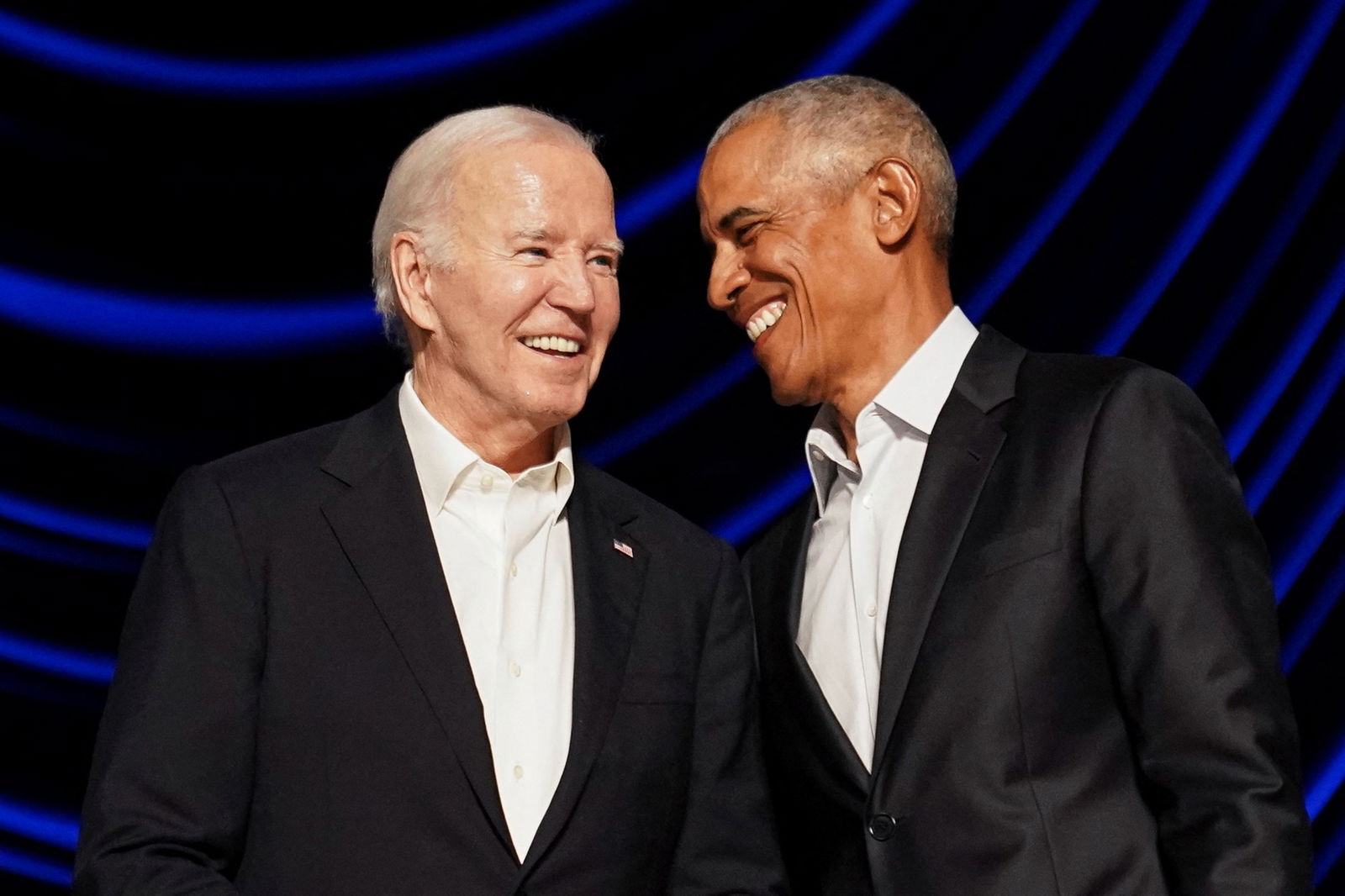 Obama smiles at Biden on stage