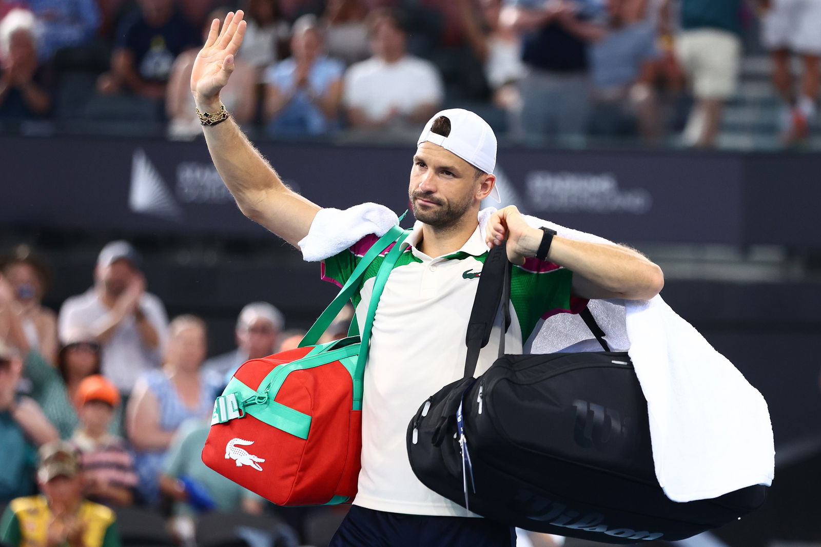 Grigor Dimitrov waves to the crowd.