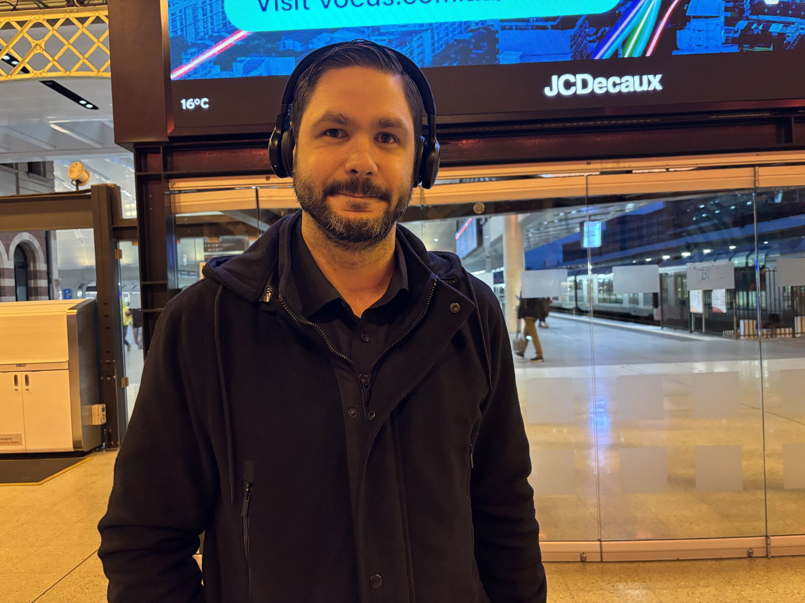 Man with headphones and black jacket