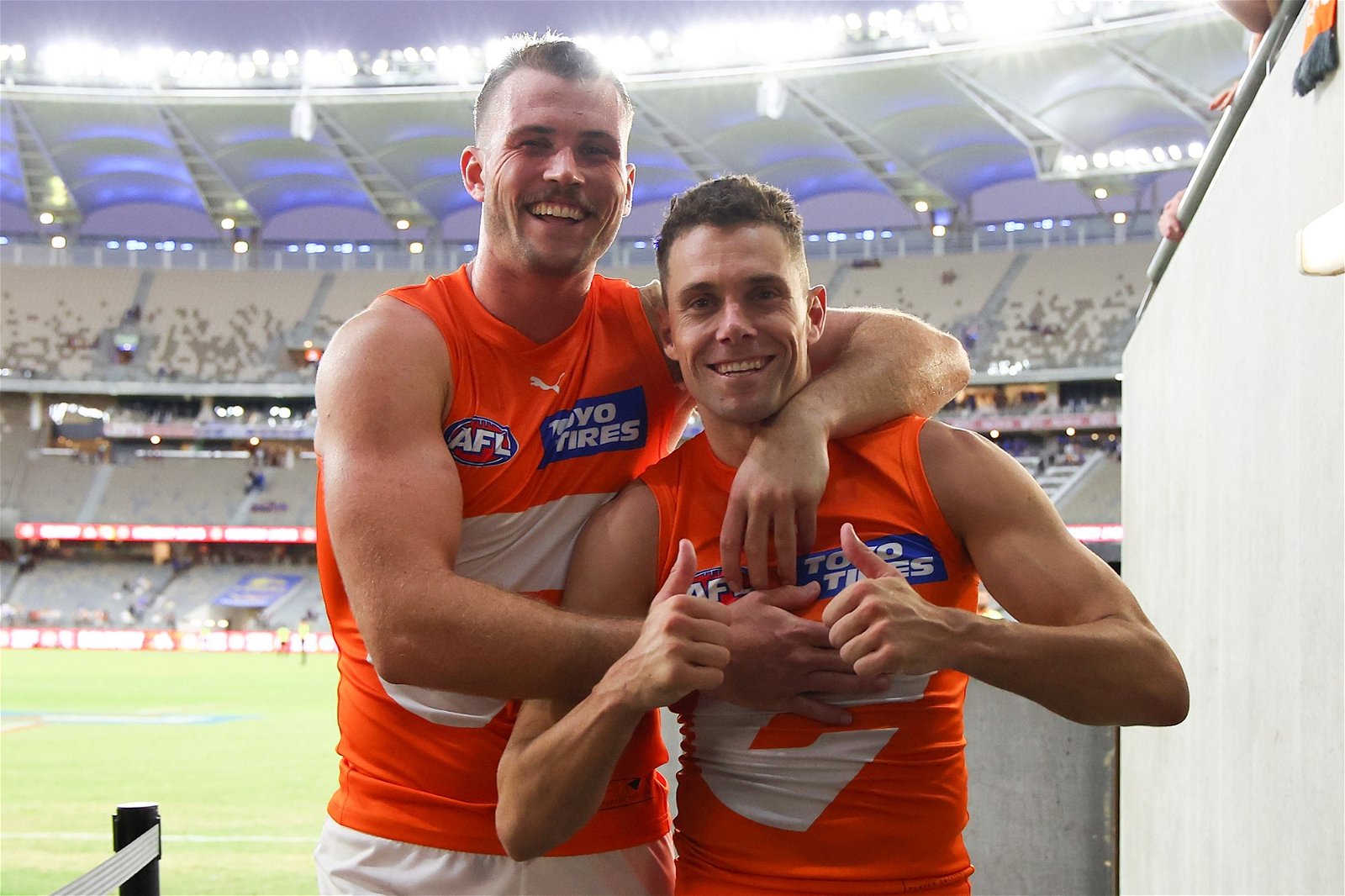 Kieren Briggs and Josh Kelly celebrate after the Giants' win over West Coast in Perth.
