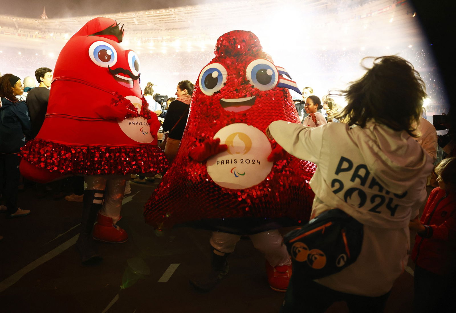 Paralympics mascots are dancing in the crowd during the closing ceremony