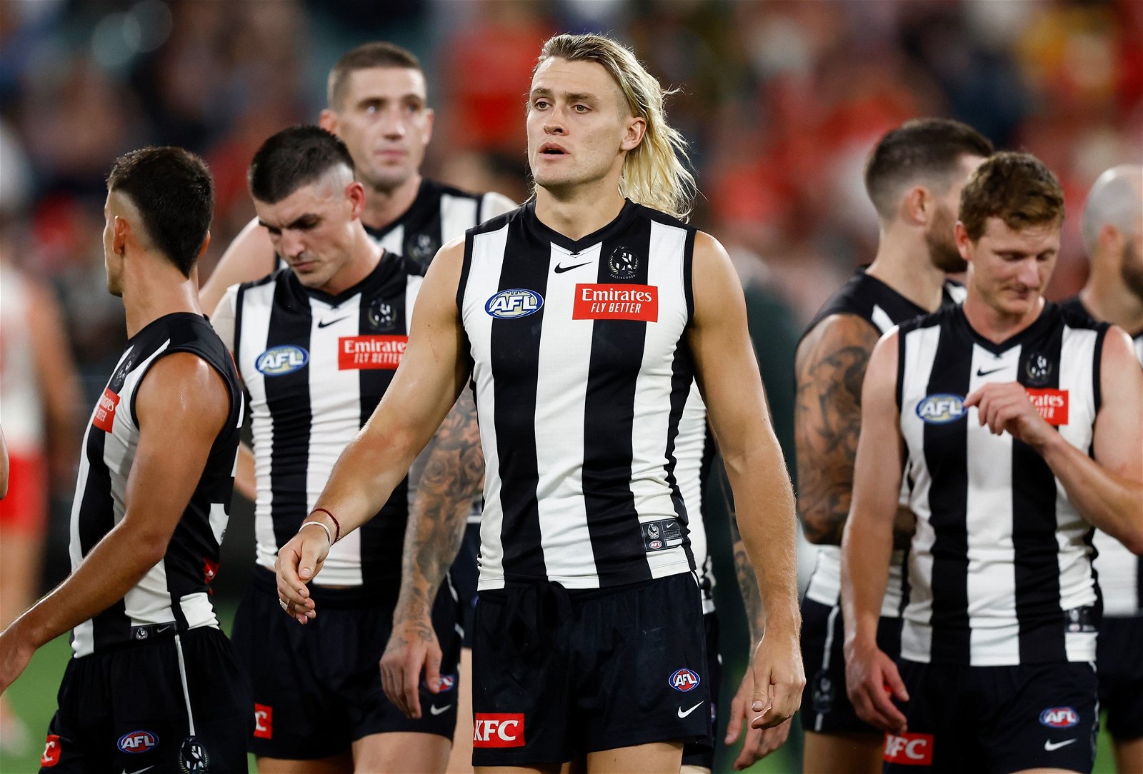 Collingwood captain Darcy Moore walks off with his team after a loss at the MCG.