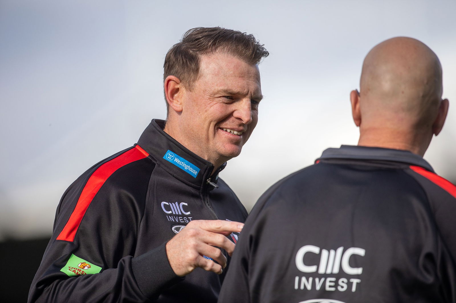 Brendon Goddard speaks to a fellow Saints coach.