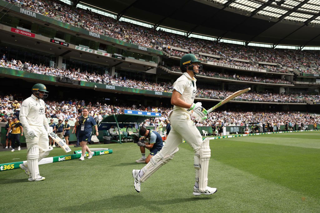 Sam Konstas runs out ahead of Usman Khawaja.