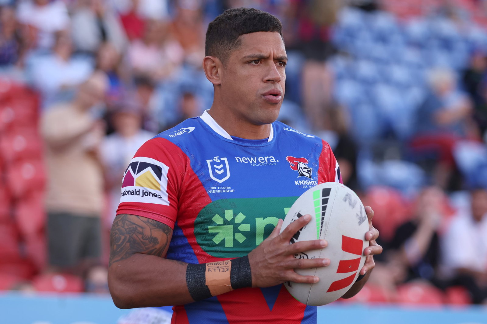 Dane Gagai holding the football in two hands while on the field